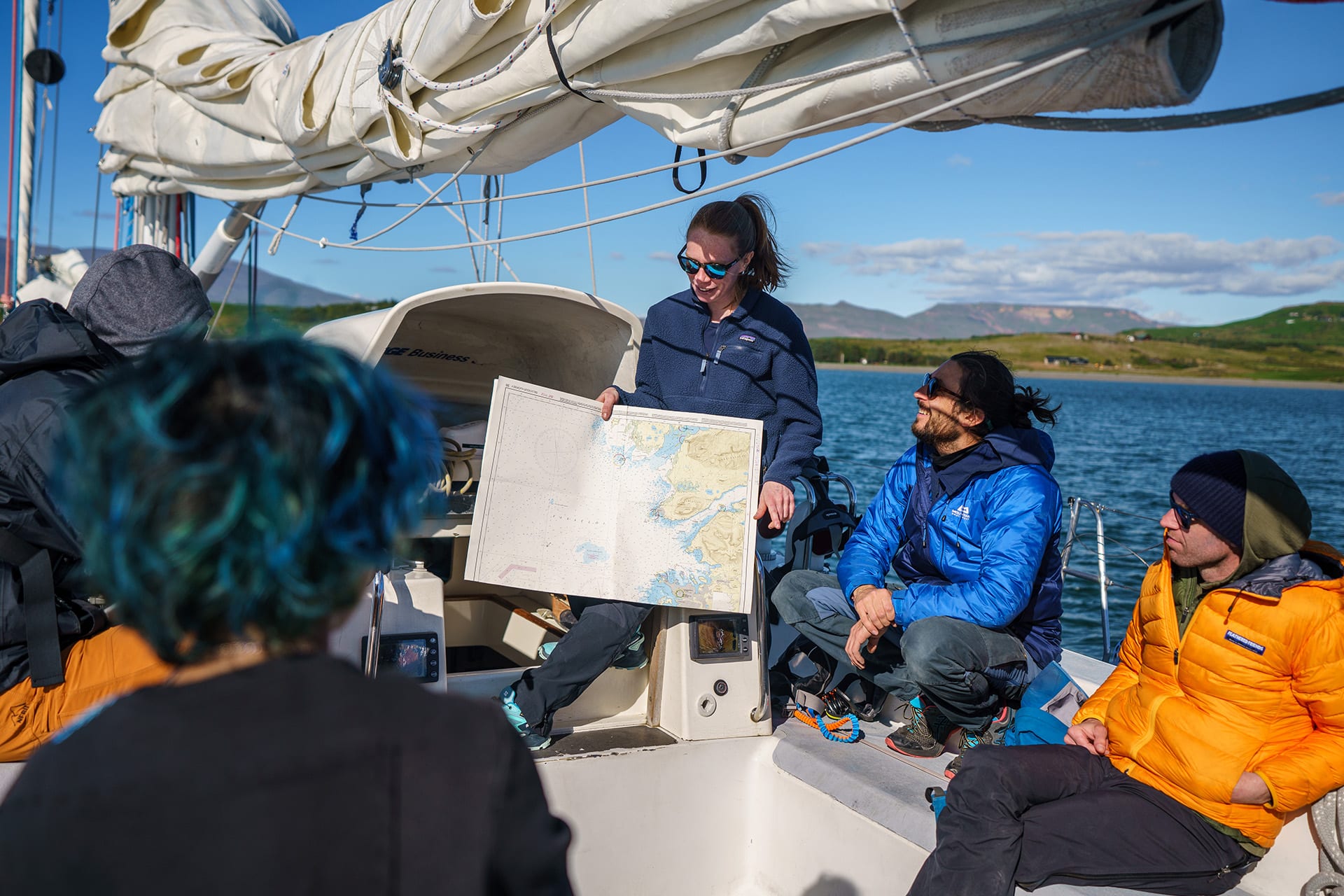 Sea Dragon guests on deck looking at map navigation underway sailing