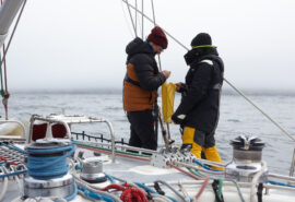 Sea Dragon sailing yacht guests on deck learning ropes