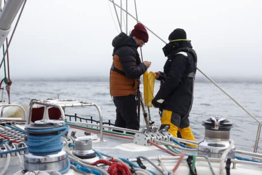 Sea Dragon sailing yacht guests on deck learning ropes
