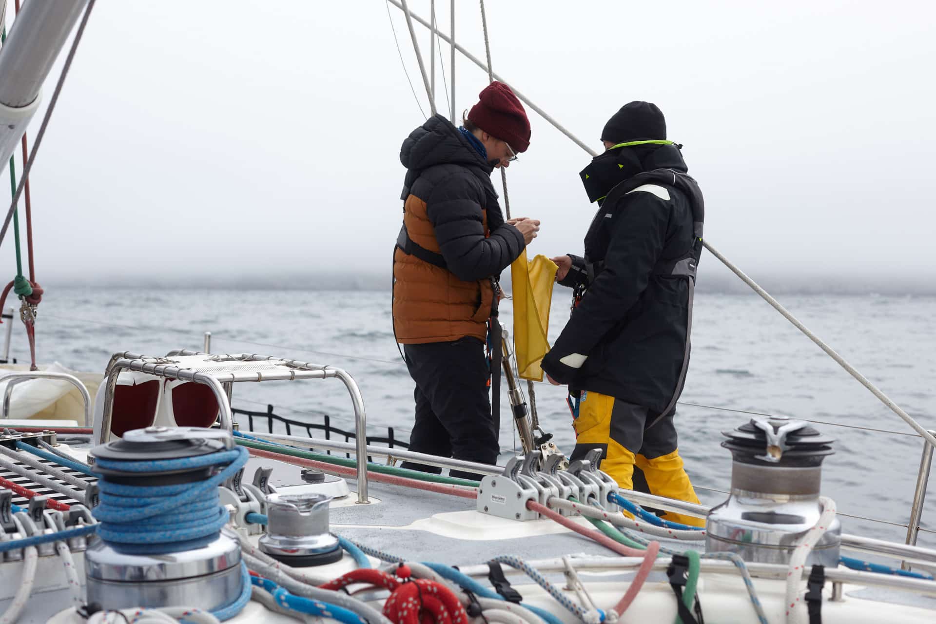 Sea Dragon sailing yacht guests on deck learning ropes