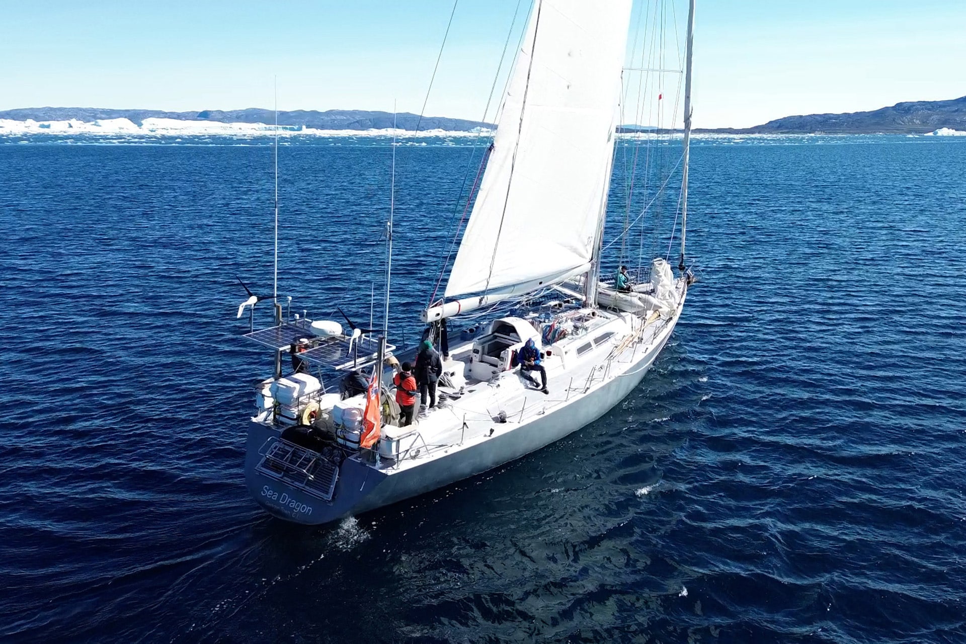 Sea Dragon sailing yacht underway from stern in Arctic Circle Greenland -