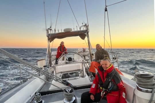 Sea dragon guests onoard adventure sailing at sunset open ocean -