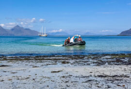 Steady guests coming ashore via tender, Hebrides beach, Scotland