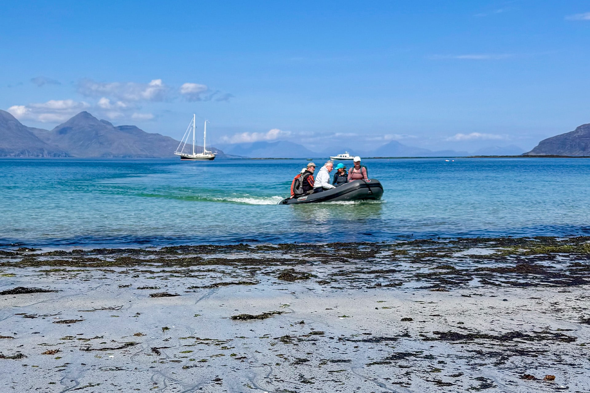 Steady guests coming ashore via tender, Hebrides beach, Scotland