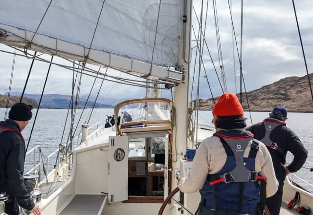 Steady guests onboard yacht sailing through the lochs in the Caledonian Canal, Scottish highlands, Scotland