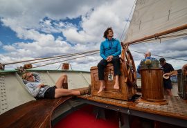 Tecla guests relaxing on deck under sail