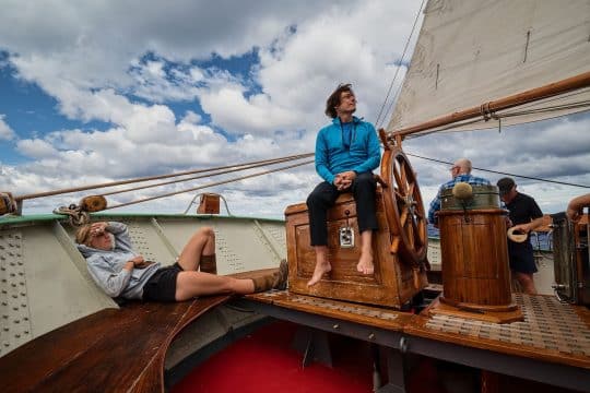 Tecla guests relaxing on deck under sail