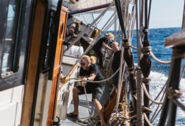 Twister guest pulling ropes on deck adventure sailing