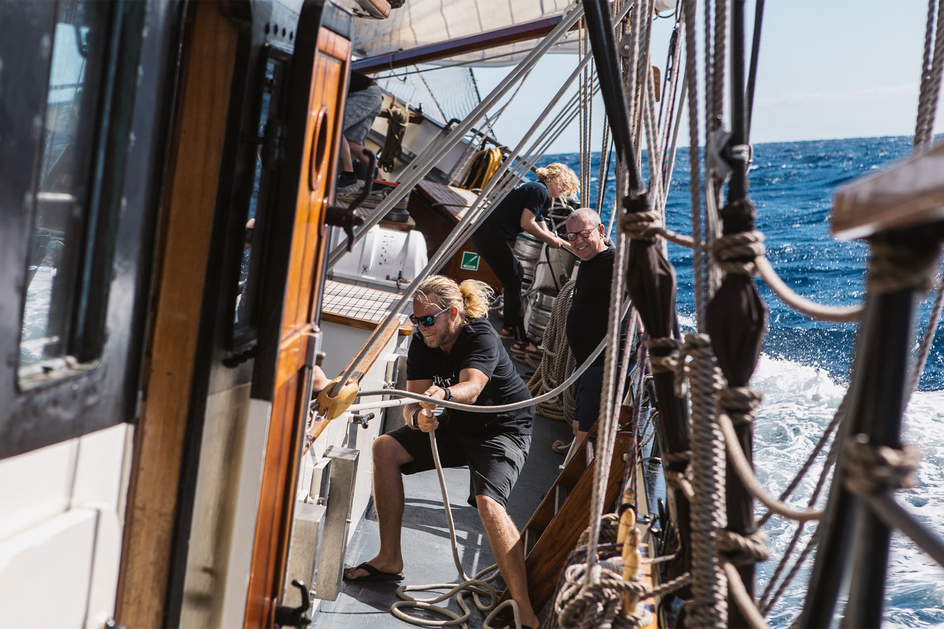 Twister guest pulling ropes on deck adventure sailing