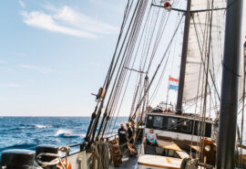 Twister guests on deck of schooner underway sailing