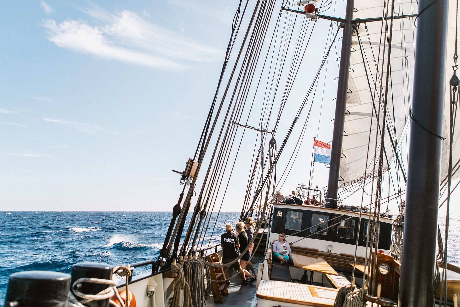 Twister guests on deck of schooner underway sailing