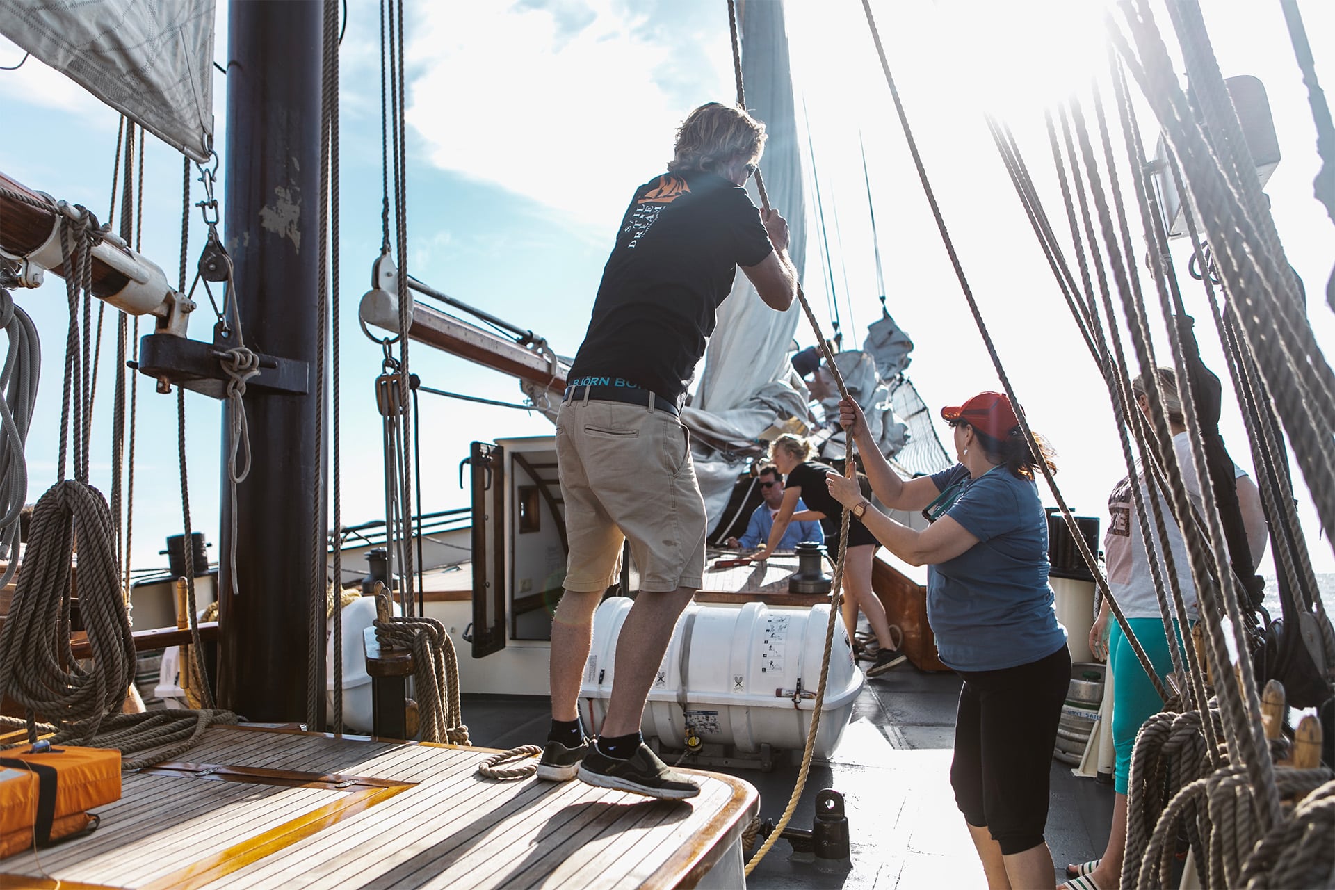 Twister guests onboard pulling ropes on deck adventure sailing