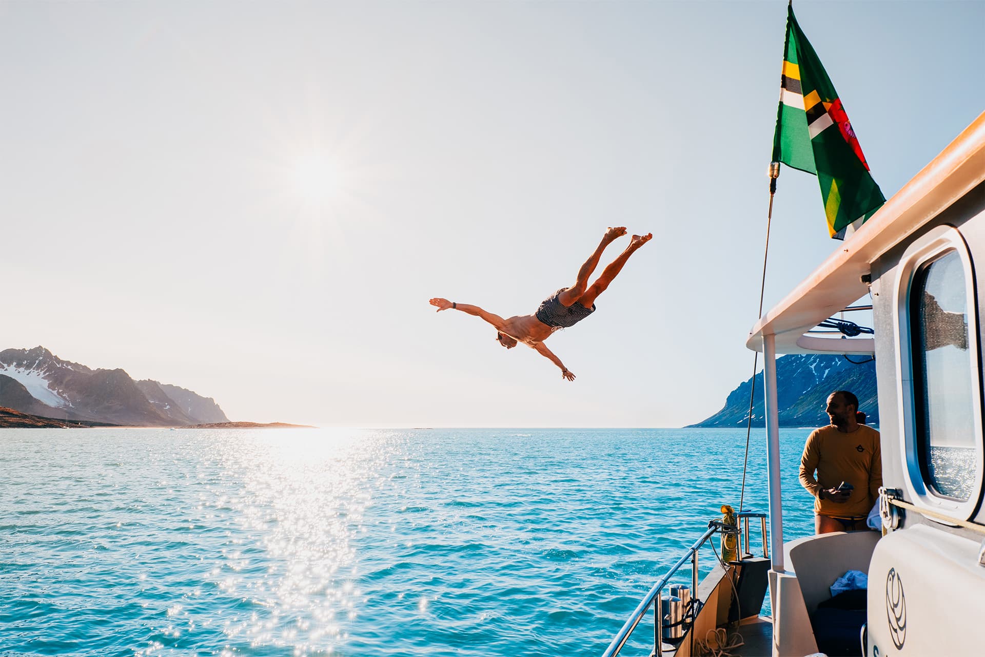 Valiente guest diving in from boat in Svalbard summer