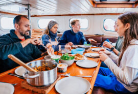 Valiente guests eating dinner onboard