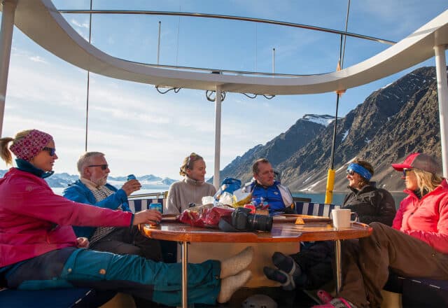 Valiente guests on deck in Svalbard eating on deck dining Arctic Circle Norway