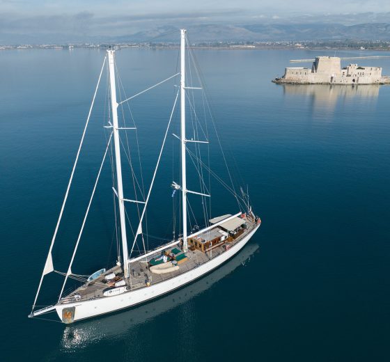 View of Kairos anchored in calm waters in the Mediterranean