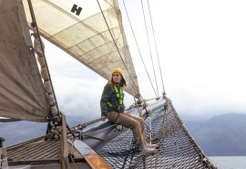 Woman on bowsprit of Blue Clipper