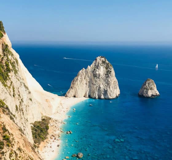 Yacht sailing off the coast of cliffs on Zante, Zakynthos, Ionian islands Greece