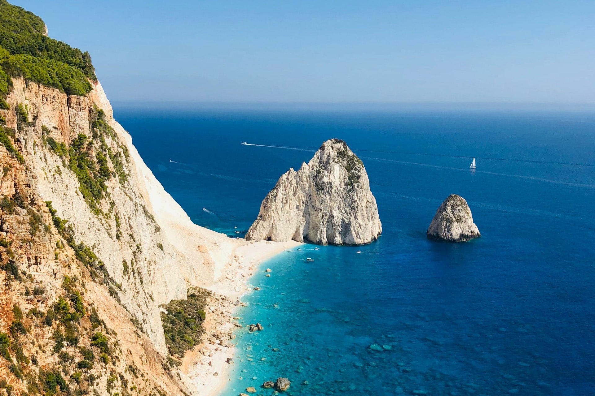 Yacht sailing off the coast of cliffs on Zante, Zakynthos, Ionian islands Greece
