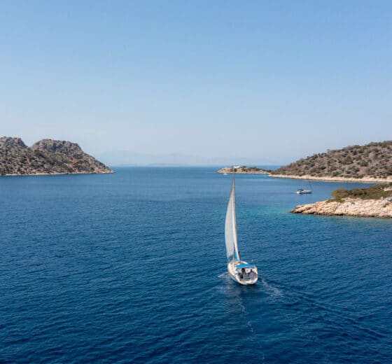 Zorba yacht sailing in full sail from stern in Saronic islands, greece