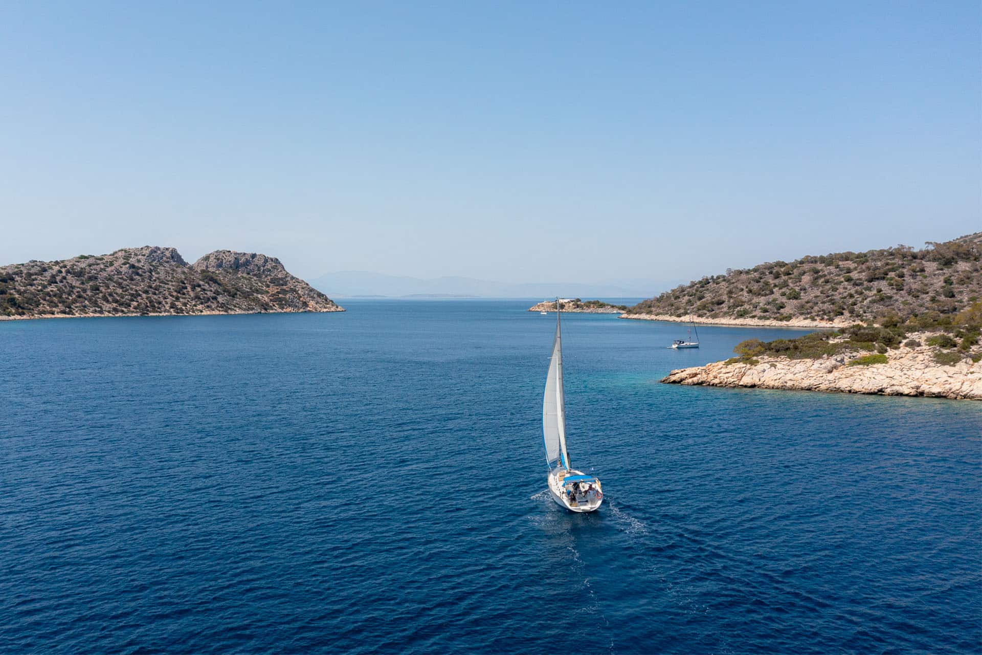 Zorba yacht sailing in full sail from stern in Saronic islands, greece