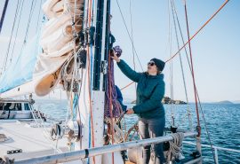 Zuza guest winching sails onboard
