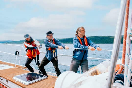 Zuza guests and crew onboard pulling ropes sailing