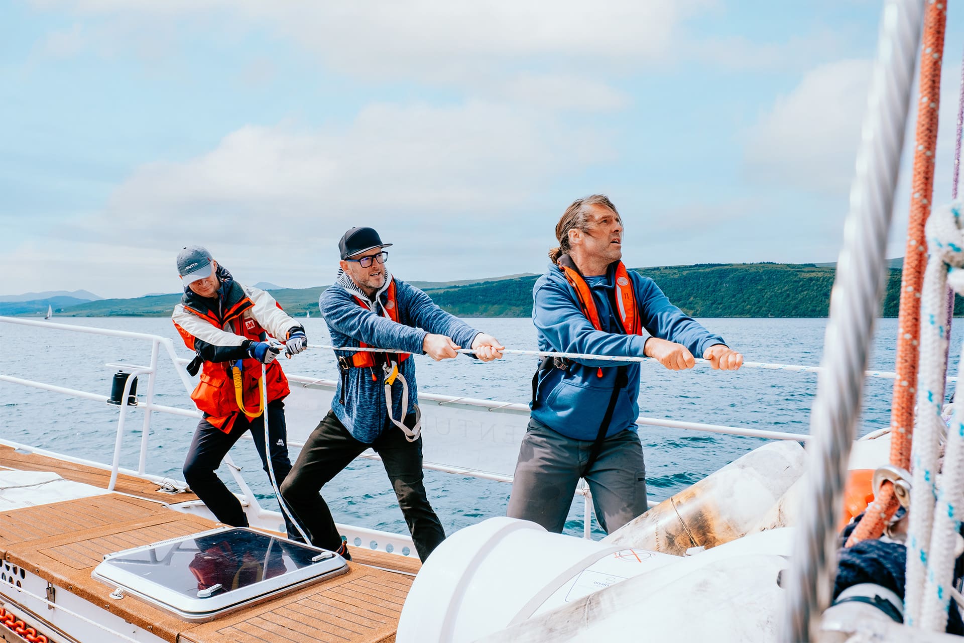 Zuza guests and crew onboard pulling ropes sailing