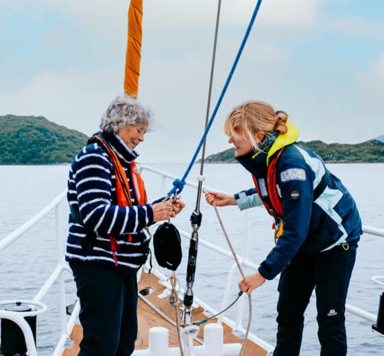 Zuza guests onboard ropework women sailors at bow