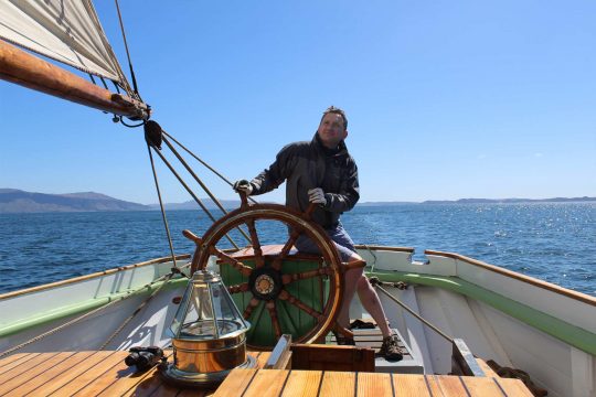 On the helm of a tall ship